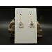 Machine embroidered tiny sand dollar earrings. Tan in color with blue and brown accents. Gold hypoallergenic hooks.